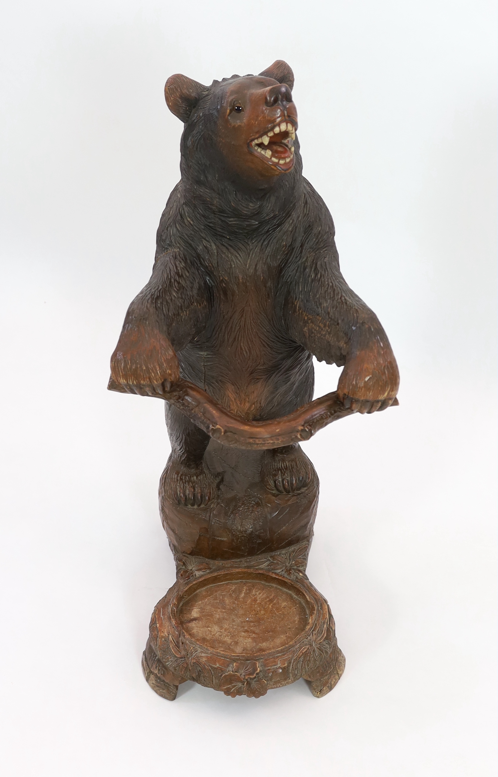 A late 19th century Black Forest carved wood bear stick stand